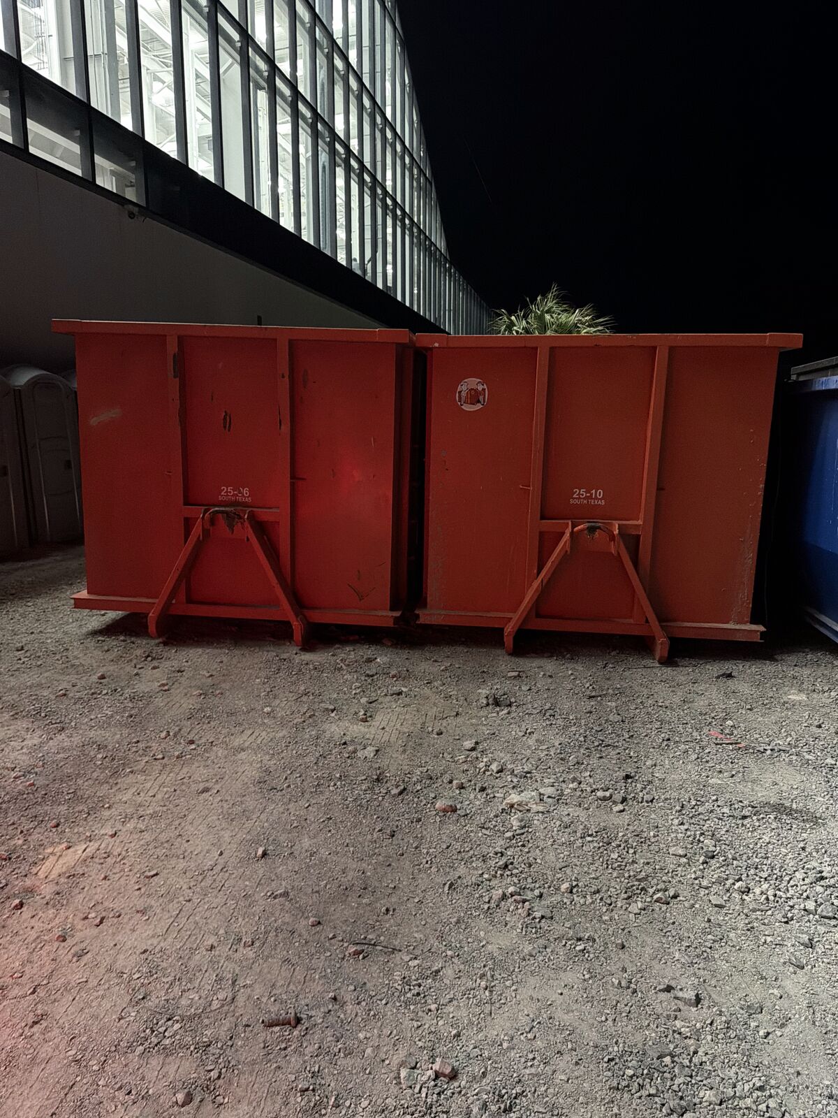 Two 25-yard roll-off dumpsters at a commercial job site in South Texas