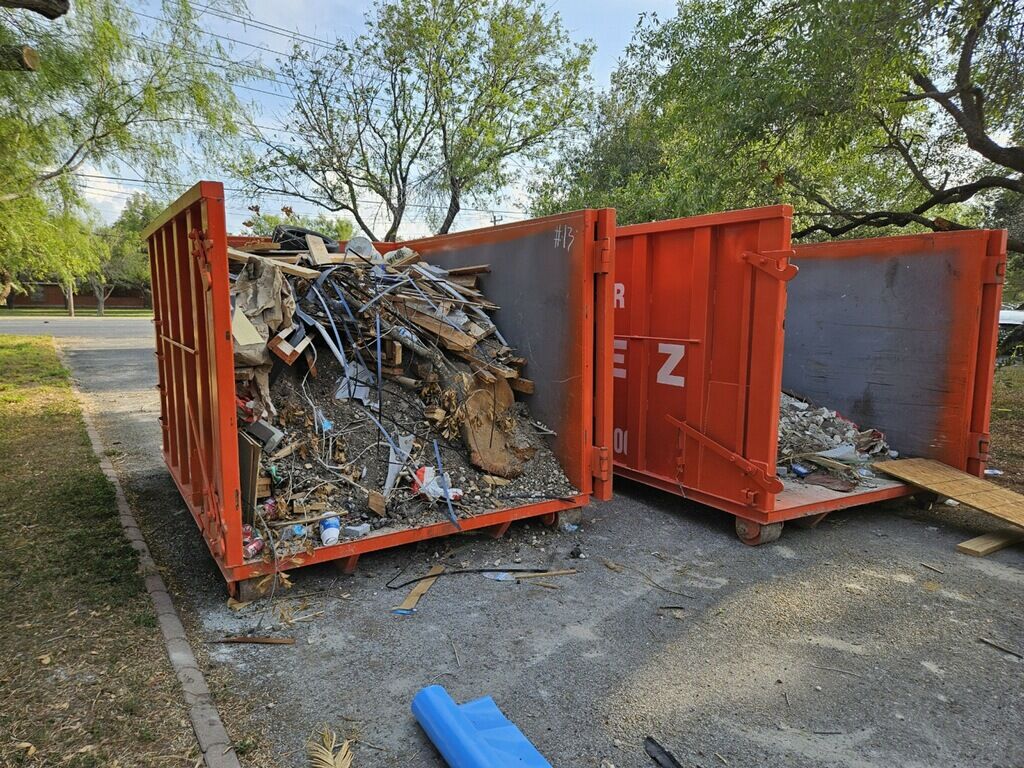 Construction dumpster rental full of remodeling and roofing debris in the RGV