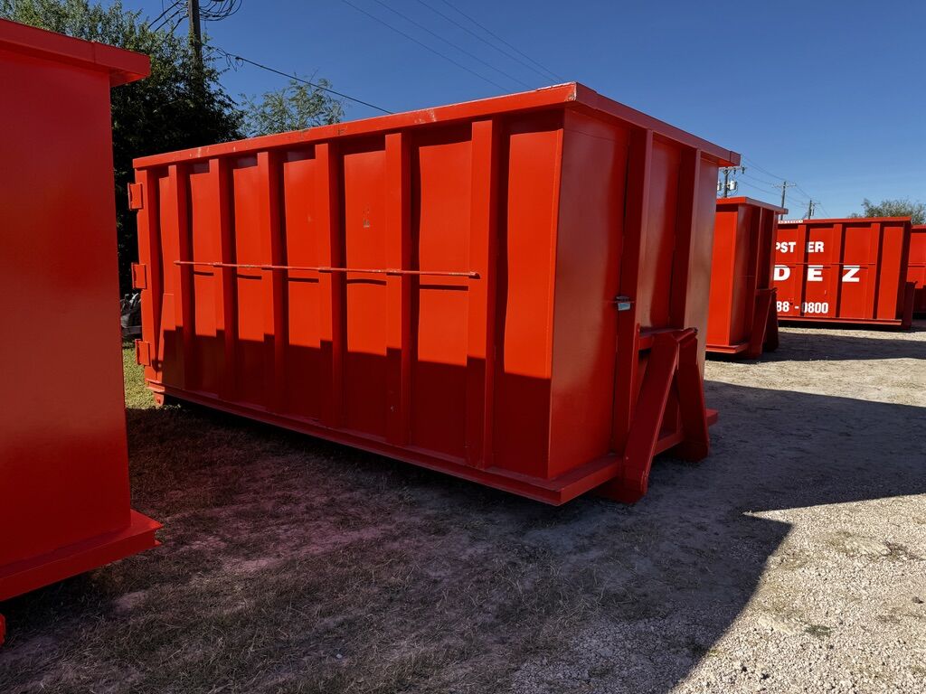International-orange roll-off dumpster container ready for rental in the Rio Grande Valley